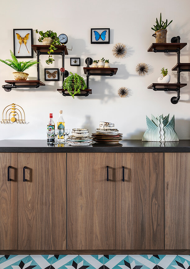 Wood grain cabinets under modern industrial pipe shelves